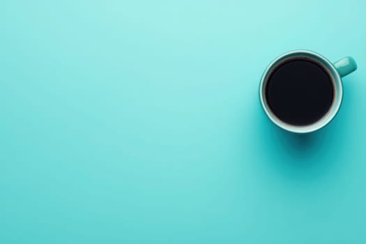 An office desk showcases a clean and minimalistic design featuring a coffee cup filled with dark coffee on a solid turquoise background. This setup invites a focused work atmosphere.