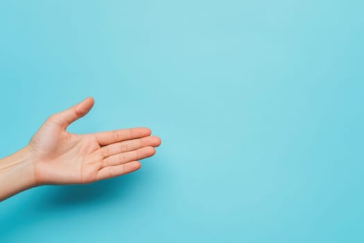 An open palm extends outward against a clean light blue background, symbolizing a welcoming gesture. This hand position suggests openness and readiness for interaction.