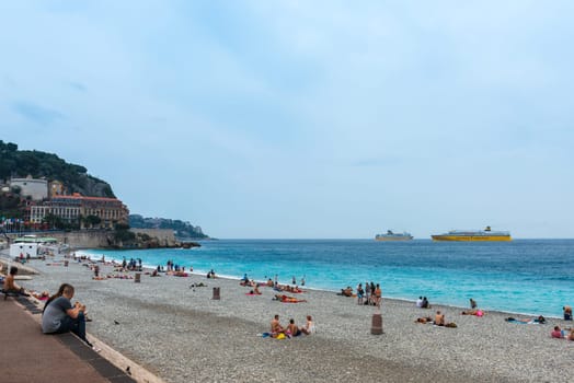 FRANCE, NICE - JUNE 13: people on the beach of the Mediterranean sea. Cote d Azur, Nice, France on June 13, 2015