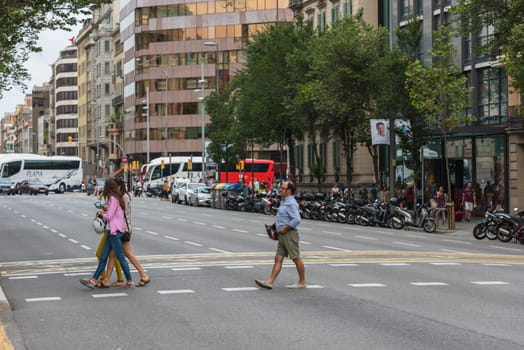 SPAIN, BARCELONA - SEPTEMBER 12: People on a crosswalk, Barcelona street on September 12, 2015