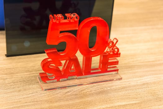 Sale signs with big reductions in shop window