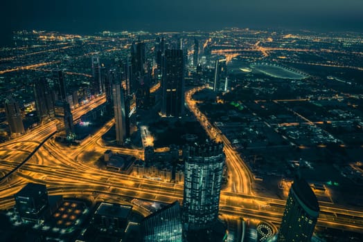 Dubai downtown night scene with city lights. Top view from above