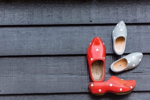 Traditional dutch wooden shoes hanging at a wall. Background