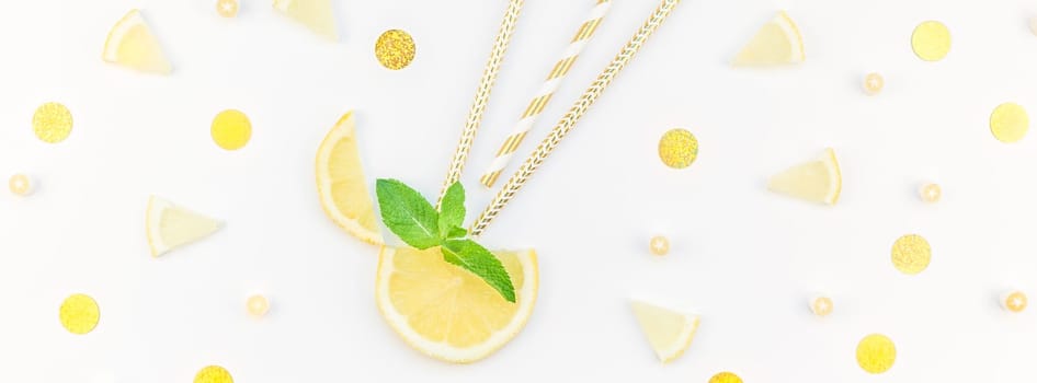 Long wide banner top view citrus lemon slices and mint herbs leaves white table background with copyspace. Hot summer refreshment lemonade concept. Beverage ingredients arranged with straws