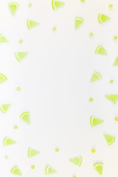 Creative flatlay overhead top view citrus lemon slices pattern frame white table background with copyspace. Hot summer refreshment lemonade concept. Beverage ingredients arranged