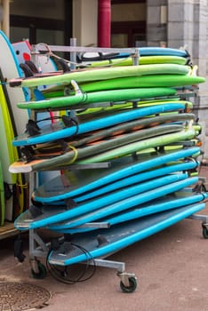 Set of different color surf boards in a stack. France