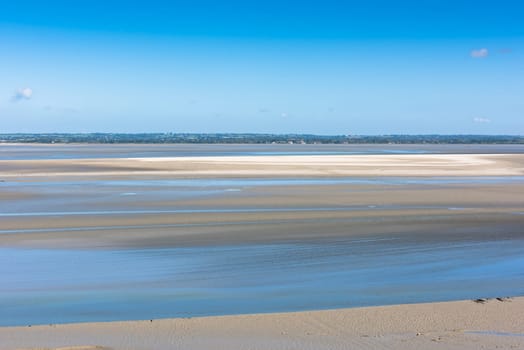 View from walls of Mont Saint Michel on the bay during the low tide. France