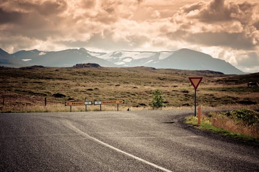 Road junction and waymarks at North Iceland mountain landscape. Filtered Image