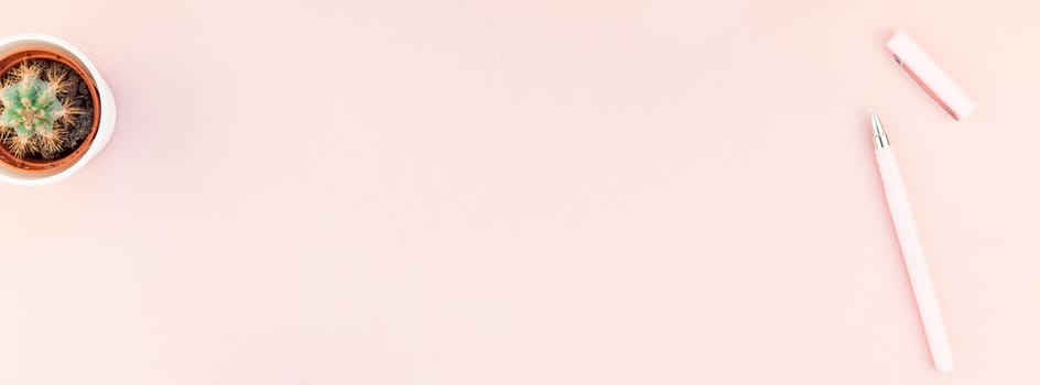 Creative flat lay overhead top view small pots with decorative cactuses plants with copy space on millennial pink paper background in minimalism style. Long wide banner for feminine blog, social media