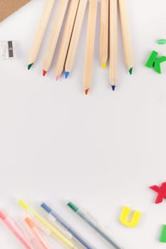 Creative flat lay back to school concept with color school and office supplies on white table background with copy space, frame, template for text or design