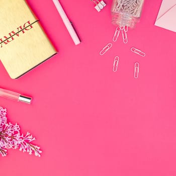 Top view flat lay of workspace desk styled design office supplies with copy space on a bright pink color paper background minimal style. Square Template for feminine blog social media