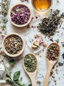 Assorted dried herbs and flowers with a cup of tea, perfect for brewing herbal infusions.