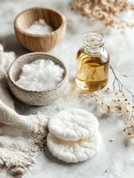 A selection of natural skincare products including oil and cotton pads, arranged in a calming setting.