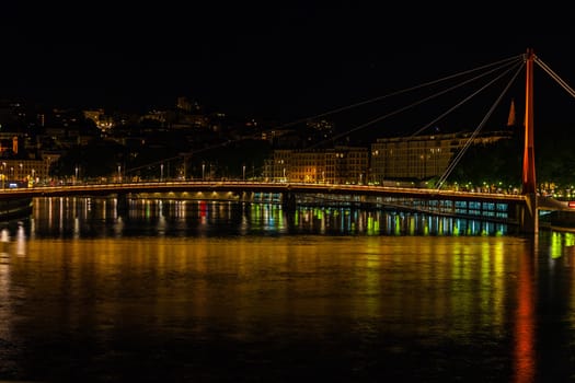 Cityscape of Lyon, France with reflections in the water at night