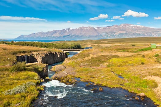 Summer Iceland Landscape with River, Mountains and Bright Blue Sky
