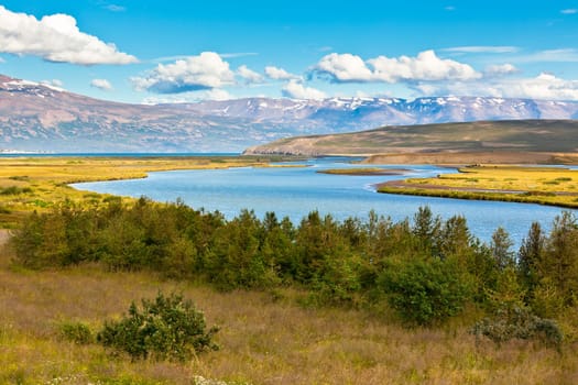 Summer Iceland Landscape with River, Mountains and Bright Blue Sky