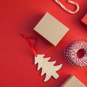 New Year Christmas presents wrapped with ribbon flat lay top view Xmas holiday 2019 celebration handmade gift boxes red paper background copyspace. Square Template mockup for greeting card text design