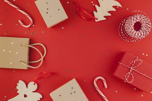 New Year Christmas presents wrapped ribbon flat lay top view Xmas holiday 2019 celebration handmade gift boxes red paper golden sparkles background copyspace. Template mockup greeting card text design