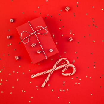New Year or Christmas presents wrapped ribbon flat lay top view Xmas holiday 2019 celebration handmade gift boxes red paper golden sparkles background. Square Template mockup greeting card text design
