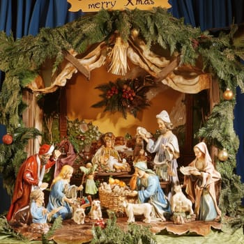 A detailed nativity display showcases the birth of Jesus with figures and animals surrounded by greenery and decorations during the holiday season.