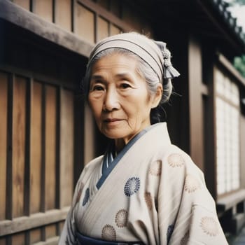 A graceful Japanese woman 70 years old wears a traditional kimono adorned with floral patterns while posing in beautiful garden. The tranquil surrounding enhance her dignified presence. Generative AI.