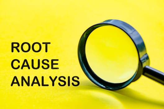Root Cause Analysis text on yellow cover with magnifying glass background. Business solution concept.