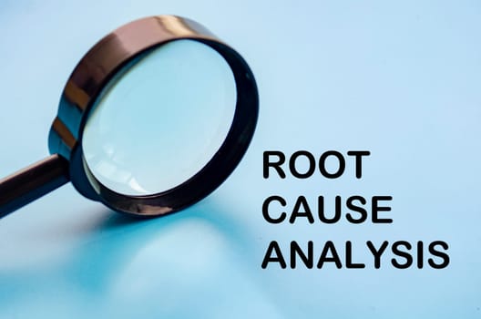 Root Cause Analysis text on blue cover with magnifying glass background. Business solution concept.