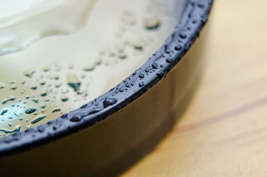 Close up of wet magnifying glass with customizable space for text or ideas.