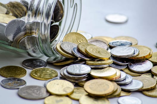 Golden coins and jar represent business, investment or any monetary concept. With customizable space for text.