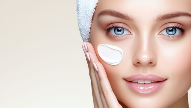 Beautiful woman applying moisturizer cream. Concept of skincare, beauty, and cosmetics.