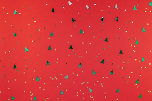 New Year or Christmas pattern flat lay top view Xmas holiday 2019 celebration red paper golden and green sparkles confetti background. Template for greeting card your text design