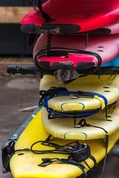 Set of different color surf boards in a stack. France