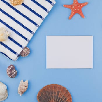 Creative square flat lay concept of summer travel vacations. Top view of beach towel and seashells and starfish on pastel blue background with copy space in minimal style, template for text