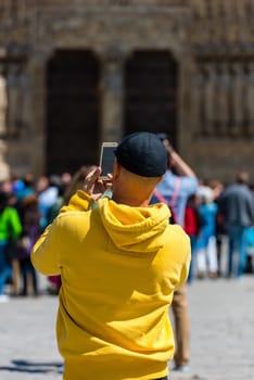 FRANCE, PARIS - JUNE 01: Man taking pictures of the Notre Dame Cathedral in Paris on June 01, 2015