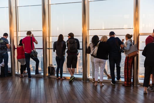 DUBAI, UAE - JANUARY 02: people at the top the observation deck of the highest building in the world Burj al Khalifa on January 02, 2015 in Dubai, United Arab Emirates