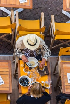 FRANCE, SAINT-MALO - SEPTEMBER 25: people are having mussels lunch at the outdoor restaurant in France on September 25, 2015. Top view