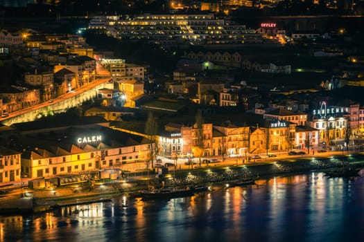 PORTUGAL, PORTO - JANUARY 20: Overview of Vila Nova de Gaia, district of Porto, Portugal at night on January 20, 2013. The world famous Port wine is stored here.