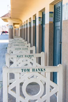 FRANCE, DEAUVILLE - SEPTEMBER 27: original beach closets with famous names on promenade Des Planches in Deauville, France on September 27, 2015