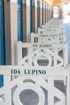 FRANCE, DEAUVILLE - SEPTEMBER 27: original beach closets with famous names on promenade Des Planches in Deauville, France on September 27, 2015
