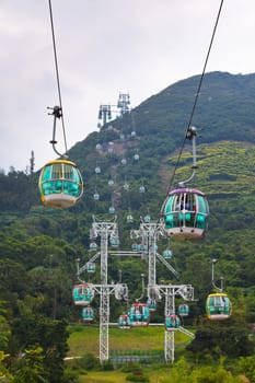 HONG KONG, HONG KONG - OCTOBER 01: cable cars over tropical trees in Hong Kong on October 01, 2012