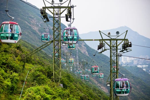 HONG KONG, HONG KONG - OCTOBER 01: cable cars over tropical trees in Hong Kong on October 01, 2012