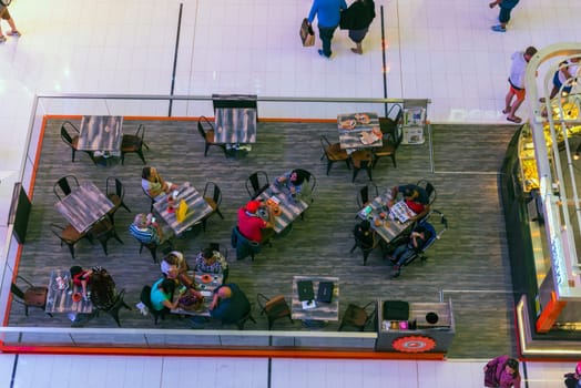UAE, DUBAI - DECEMBER 25: people in a cafe in Dubai Mall shopping center on December 25, 2014. Top view