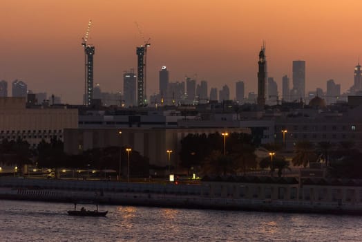 UAE, DUBAI - DECEMBER 27: view of Dubai cityscape from Dubai creek bank at night on December 27, 2014