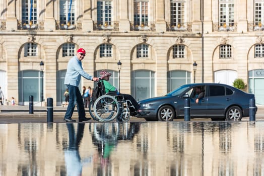 FRANCE, BORDEAUX - SEPTEMBER 20: People visiting a mirror fountain in front of Place de la Bourse in Bordeaux, France on September 20, 2015