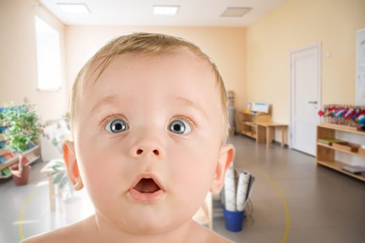Cute toddler baby at Montessori school closeup portrait