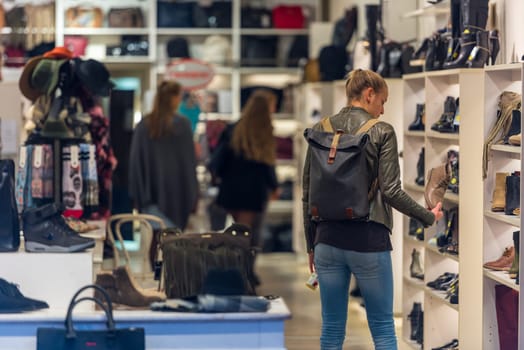 NETHERLANDS, AMSTERDAM - OCTOBER 2: Beautiful young woman in european shopping mall in Amsterdam on October 2, 2015