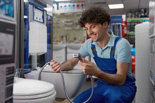 Plumber examining modern range of luxury bidets with in smart toilet technology. Best offer at plumbing store
