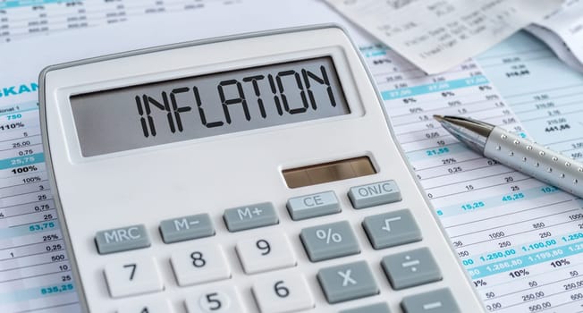 A calculator with the word Inflation on the display
