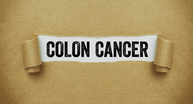 Torn paper revealing the word Colon cancer