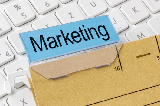 A brown file folder labeled with Marketing